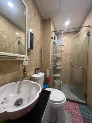 a bathroom with a sink and a toilet and a shower at Apartment 1BR Condo Manila- Suntrust Adriatico Gardens Malate in Manila