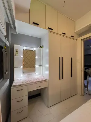 a kitchen with white cabinets and a counter top at Apartment 1BR Condo Manila- Suntrust Adriatico Gardens Malate in Manila