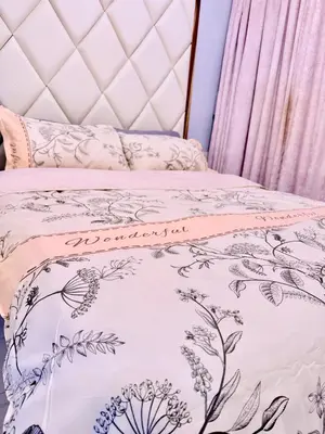 a bed with a pink and white bedspread at Apartment 1BR Condo Manila- Suntrust Adriatico Gardens Malate in Manila