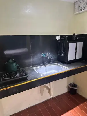 a kitchen counter with a sink and a stove at SJ Vistacation in Tanza