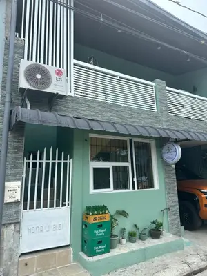 a house with a white door and a fan at SJ Vistacation in Tanza