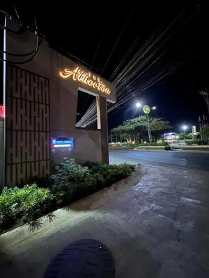 a lit up aladdin sign on the side of a building at Ezras Place Modern Condo with City views in Manila
