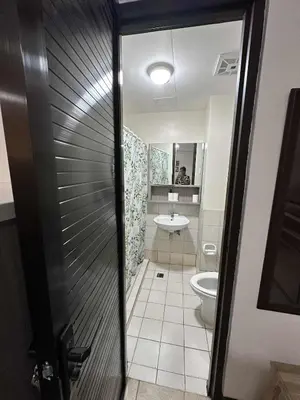 a bathroom with a toilet and a sink at Cypress Towers Staycation in Manila