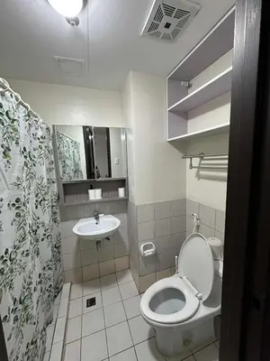 a bathroom with a toilet and a sink at Cypress Towers Staycation in Manila