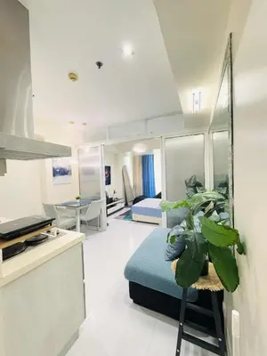 a room with a bed and a plant in it at Azure staycation By Icay in Manila