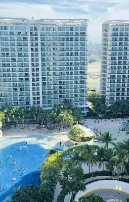 an aerial view of a resort with palm trees and buildings at Azure staycation By Icay in Manila