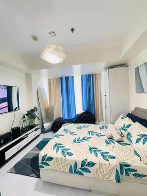 a bedroom with a bed and a flat screen tv at Azure staycation By Icay in Manila