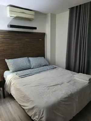 a bedroom with a large bed with a wooden headboard at Lancaster Hotel Manila Executive Suite Room 1001 in Manila