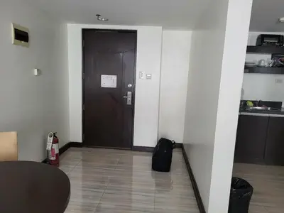 a hallway with a brown door in a room at Lancaster Hotel Manila Executive Suite Room 1001 in Manila