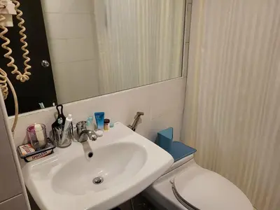 a bathroom with a sink and a toilet and a mirror at Lancaster Hotel Manila Executive Suite Room 1001 in Manila