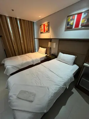 a hotel room with two beds and a window at Antel Spa Residences 1014 in Manila