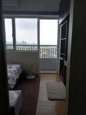 a room with a bed and a large window at John's place near BGC and Airport in Manila
