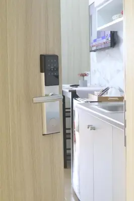 a kitchen with white cabinets and a refrigerator at John's place near BGC and Airport in Manila