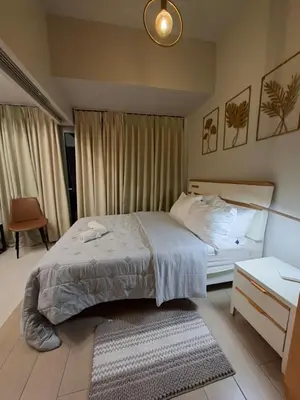 a bedroom with a bed and a nightstand and a bed sidx sidx sidx sidx at Mysuites2go24K Parksuites T2 in Manila