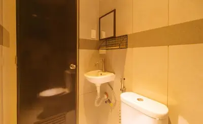 a small bathroom with a sink and a toilet at UrbanView at Mherylle's Apartment near UST Manila in Manila