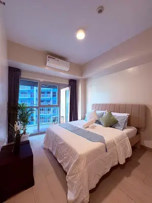 a bedroom with a large bed and a large window at 2BR at Bayshore 2 Near Okada & Airport in Manila