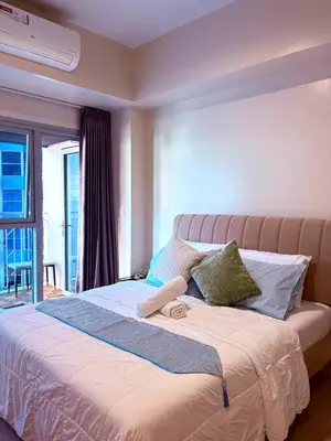 a large bed in a room with a window at 2BR at Bayshore 2 Near Okada & Airport in Manila