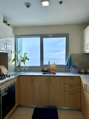 a kitchen with a sink and two large windows at 2BR at Bayshore 2 Near Okada & Airport in Manila