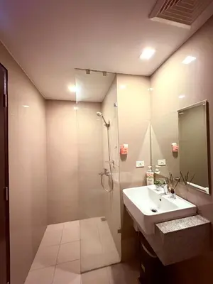 a bathroom with a sink and a shower at 2BR at Bayshore 2 Near Okada & Airport in Manila
