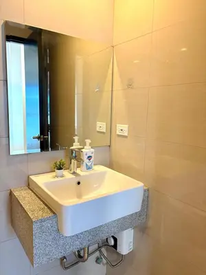 a bathroom with a white sink and a mirror at 2BR at Bayshore 2 Near Okada & Airport in Manila