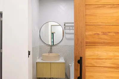 a bathroom with a sink and a mirror at Ephram House - A-Frame Cabin Staycation with Pool, Games & BBQ For Up To 20 Guests in Bacoor