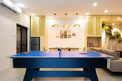 a blue ping pong table in a living room at Ephram House - A-Frame Cabin Staycation with Pool, Games & BBQ For Up To 20 Guests in Bacoor