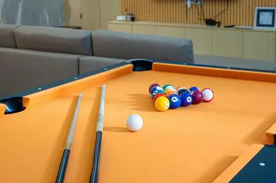 a pool table with balls and cuesticks on it at Ephram House - A-Frame Cabin Staycation with Pool, Games & BBQ For Up To 20 Guests in Bacoor