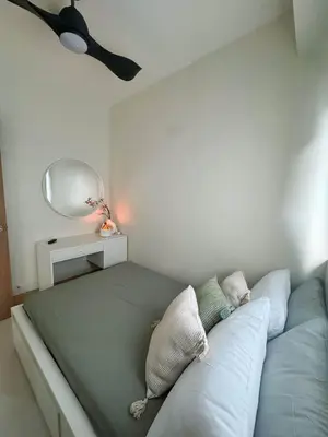 a bedroom with a blue couch with a mirror at Summer At The Shore in Manila