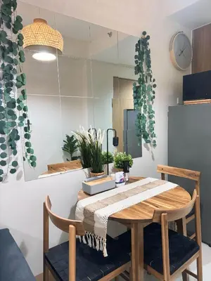 a dining room table and chairs with a mirror at Summer At The Shore in Manila