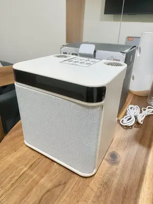 a white printer sitting on top of a wooden table at Summer At The Shore in Manila