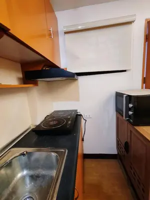 a kitchen with a sink and a microwave at Charming 2BR Condo in Cambridge with WIFI, Smart TV in Cainta