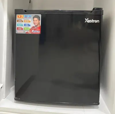 a black refrigerator with a sticker on the side of it at Charming condo unit Across US Embassy in Manila