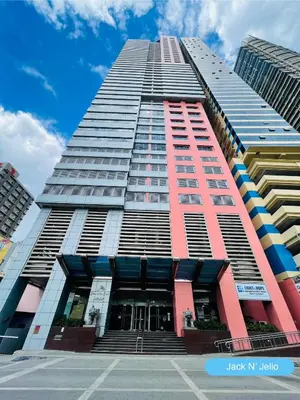 a tall building with a lot of windows at Charming condo unit Across US Embassy in Manila