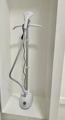 a white hair dryer in a corner of a room at Charming condo unit Across US Embassy in Manila