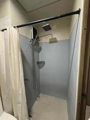 a bathroom with a shower with a shower curtain at Mystix's Pad in Manila