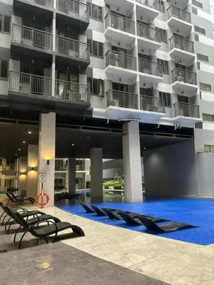 a large apartment building with a large swimming pool at Mystix's Pad in Manila