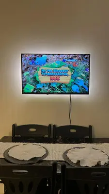 a flat screen tv on a wall above a table at Shore 2 Residences - The Grand Haven II in Manila