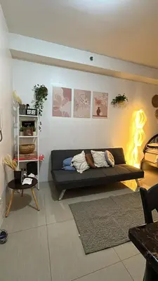 a living room with a couch in a room with lights at Shore 2 Residences - The Grand Haven II in Manila