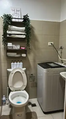 a bathroom with a toilet and a sink at Shore 2 Residences - The Grand Haven II in Manila