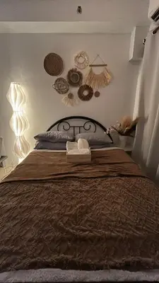 a bedroom with a large bed with decorations on the wall at Shore 2 Residences - The Grand Haven II in Manila