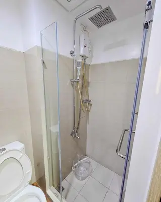 a bathroom with a shower and a toilet at Grand Line Hideout in Manila