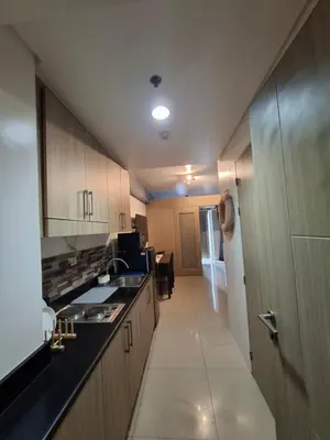 a kitchen with a sink and a counter top at Grand Line Hideout in Manila