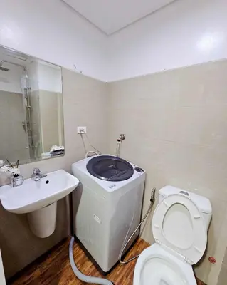 a bathroom with a white toilet and a sink at Grand Line Hideout in Manila