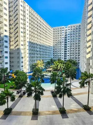 a large building with palm trees in front of it at Grand Line Hideout in Manila