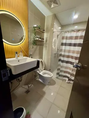 a bathroom with a sink and a toilet at Cozy Studio Near Venice Mall Netflix WIFI in Manila