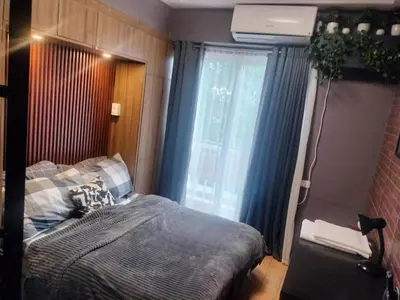a bedroom with a bed and a window at Fully Furnished Condo Near BGC in Manila