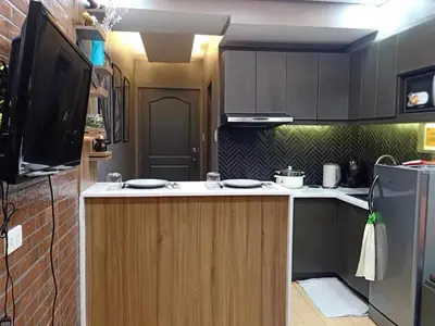 a small kitchen with a counter and a refrigerator at Fully Furnished Condo Near BGC in Manila