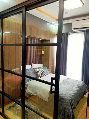 a bedroom with a bunk bed with a window at Fully Furnished Condo Near BGC in Manila