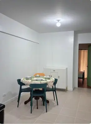 a dining room with a table and two chairs at Mid-rise staycation in parañaque in Manila