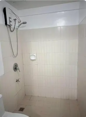 a bathroom with a shower and a toilet at Mid-rise staycation in parañaque in Manila